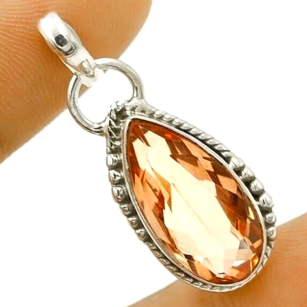 12 carat padparasha pendant.925 sramped 925 sterling silver. Light pinkish hue